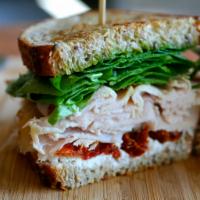 Wolfgang · turkey breast, goat cheese, sundried tomato, spinach and basil pesto on 9 grain wheat