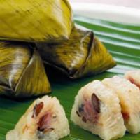 Banana Dumpling  · Steamed banana with sweet coconut sticky rice and red bean in banana leaves.