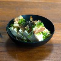 Hiyayakko · Tofu dressed with soba ginger sauce, topped with bonito flakes, green scallions, and hari no...