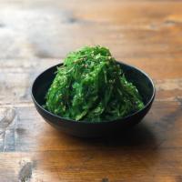 Kelp Salad · Wakame seaweed tossed in soy sauce, sesame oil, and rice vinegar, sprinkled with sesame seeds.