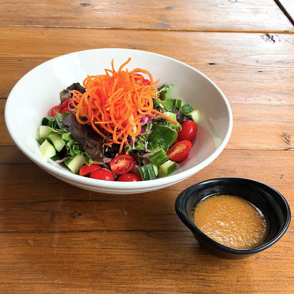 Mixed Green Salad · Spring and iceberg mixed with cucumbers, tomatoes, julienned carrots, sesame seeds, and house carrot ginger dressing.