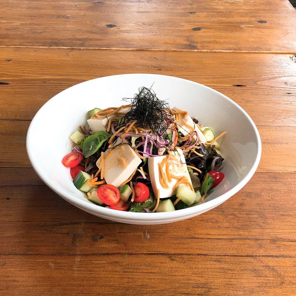Tofu Salad · Silky tofu served on a spring mix with shaved red and white cabbage, topped with hari nori. Served with goma dressing.