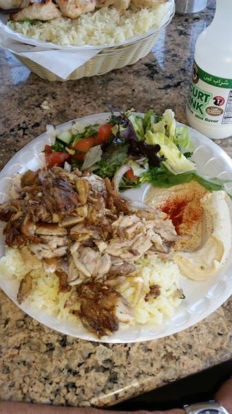 Mini Shawarma · Chicken cooked on an upright spit and served with rice, salad, hummus, and a pita.