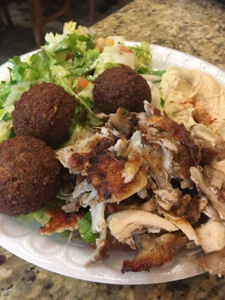 Shawarma and Falafel · Falafel: chickpeas and broad beans mixed with spices and fried. Shawarma: slices of chicken marinated with vinegar, spices, and onions grilled on an upright spit. Served with rice, salad, hummus, and pita.