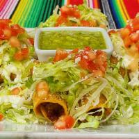 Crispy Taquitos · Two chicken and two potato filled crispy rolled tortillas, topped with lettuce, sour cream, ...