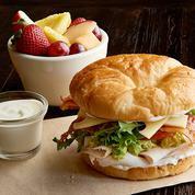 California Club · Roasted turkey breast, bacon, Swiss, guacamole, tomato, organic field greens, mayo, toasted croissant. Served with 1 side: fresh fruit, steamed veggies, baked chips or blue corn chips with salsa.