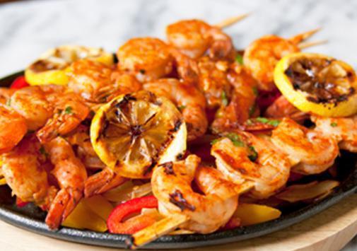 Shrimp Fajitas · Shrimp grilled with zucchini, yellow squash, onions, corn, bell peppers, and celery. Grilled with onions and bell peppers. Served with guacamole, Pico, sour cream, rice, bean soup, and tortillas.