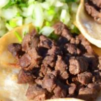 St. Seasoned Steak Tacos · Spicy. 4 open face corn tortillas served with fresh onions, cilantro, charro beans, and a si...