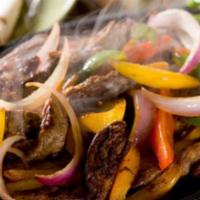 Family Fajitas · Choice of beef, chicken or combination, served with rice, beans, tortillas, sour cream and p...