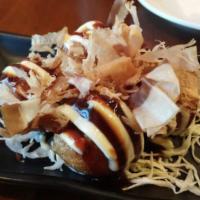 Takoyaki · Japanese snack in the shape of little round balls containing minced octopus.