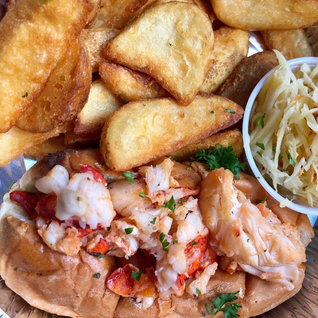 Lobster Roll Warm · 4oz lobster meat warmed w/ butter on a new england top cut bun, served w/ homemade potato chips and homemade coleslaw.