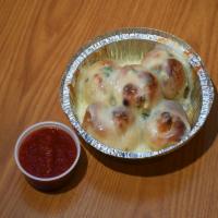 Garlic Knots with Cheese · 5 pieces. Topped with mozzarella cheese. Served with marinara sauce on the side.