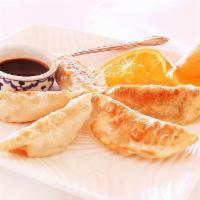8. Pot Sticker · Pan fried dumplings stuffed with chicken and vegetables, served with homemade black sauce.