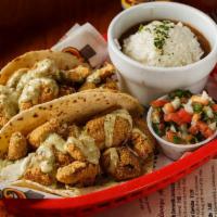 Shrimp Tacos · 2 tacos served grilled, blackened or fried on mixed flour-corn tortillas topped with Serrano...