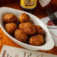 Hushpuppies · Our famous corn hushpuppies breaded with jalapeno bits throughout and fried golden brown.