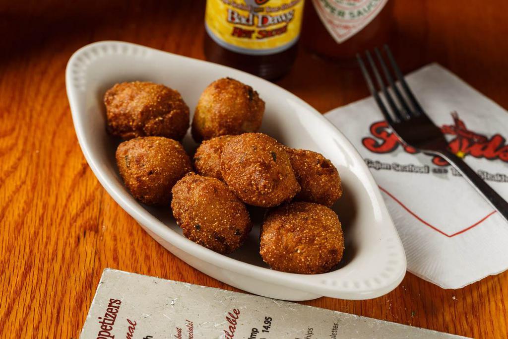Hushpuppies · Our famous corn hushpuppies breaded with jalapeno bits throughout and fried golden brown.