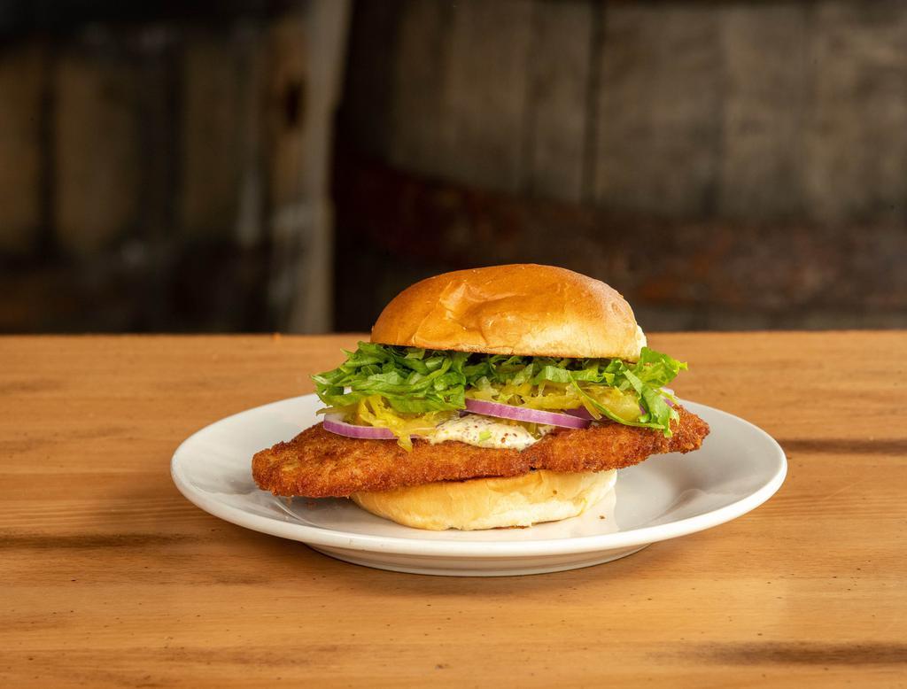 Hoosier Classic Tenderloin Sandwich · hand-breaded pork cutlet served with chow chow, shredded lettuce, red onion, pickle chips and whole grain mustard aioli 