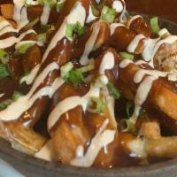Poutine · Savory beef gravy, cheese curds, and horseradish sour cream sauce over fries.