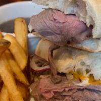 Prime Rib French Dip Sandwich · Slow roasted, thin sliced, horseradish cream sauce, cheddar, red onions, on a toasted baguet...