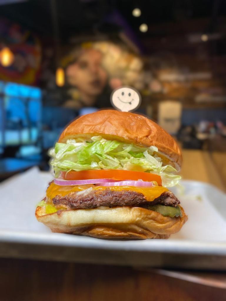 The Classic · #LiveHappy - 1/4 lb. beef patty, cheddar, tomato, onion, pickle, lettuce, and SF sauce on Hawaiian bun.
