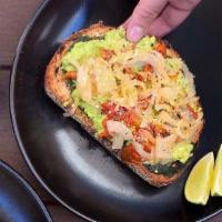 Vegan AvocaToast · Multigrain toast, vegan pesto, avocado, roasted tomatoes, and caramelized onions.