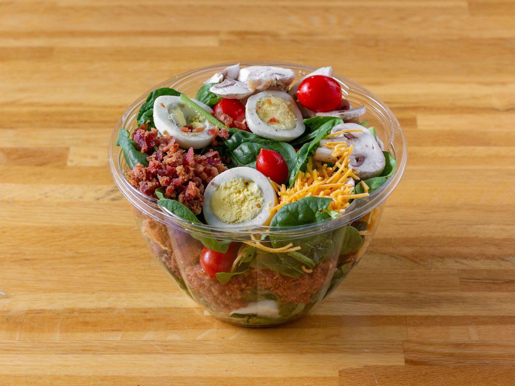Americana Spinach Salad · Fresh baby spinach with tomatoes, mushroom, hard boiled egg, bacon, cheddar cheese and croutons, with honey-balsamic vinaigrette.