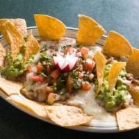 Nachos Supremos · Supreme nachos. Beans and cheese. Topped with guacamole, pico de Gallo and chips on the side. 