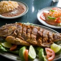 Mojarra Frita · Fried tilapia. Served with rice and  beans