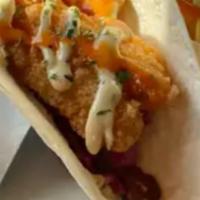 Fish Tacos · 3 blackened fish tacos over a bed of a spicy margarita slaw, topped with green chili aioli a...