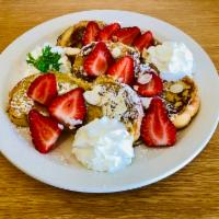 French Toast Strawberry Cream · French toast with strawberry whipped cream, sliced almond, and powdered sugar.