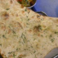 Garlic Naan · Freshly baked white bread topped with fresh garlic, cilantro and butter