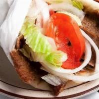 Gyro Wrap Sandwich · Spiced beef and lamb meat slices broiled and served in a toasted pita with our own tzatziki ...