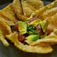 Ahi Poke with Chips Small Plate · Sashimi grade ahi tuna marinated in poke sauce. Topped with diced avocado and served with cr...