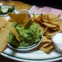 Guacamole Dip · Served with warm corn tortilla chips and house-made salsa.