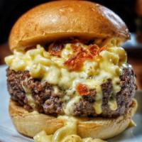 Mac N Cheese Burger · Topped with truffle mac 'n cheese, chopped bacon, cheddar and onion ring.