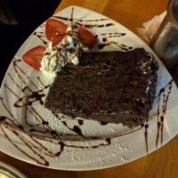 Chocolate Layer Cake · 3 layers of pure chocolate topped with whipped cream. Contains nuts.
