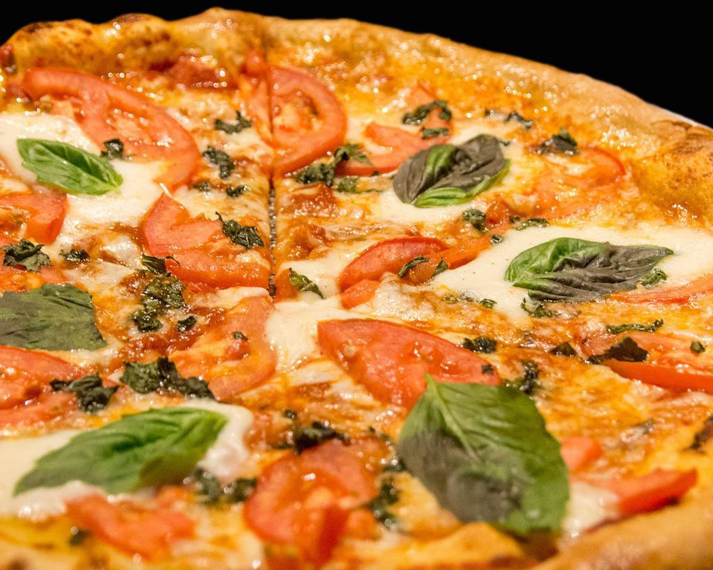 Margherita Pizza · Marinara, mozzarella, fresh tomatoes, fresh mozzarella and basil.