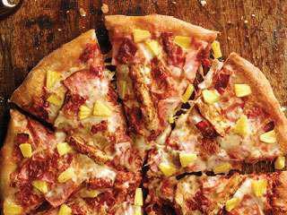 Hawaiian Chicken Pizza · Ham, grilled chicken, bacon, pineapple, our signature sauce and three-cheese blend.