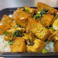 Kow Rad Ka Pow Tofu · Stir-fried diced tofu with garlic, chili, and Thai hot basil leaves in ka pow sauce over rice.