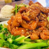 Gai Ob Yod Puk · Stir-fried crispy chicken with garlic in sweet and sour sauce served over Chinese broccoli c...