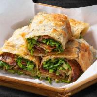 Spicy Beef Roll Pancake · 4 pieces. A thin fried flour pancake encasing slices of beef, green onions, cilantro and hoi...