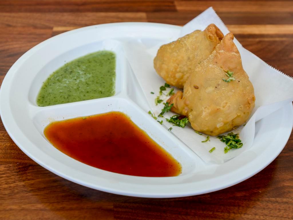 2 Pieces Samosa · Spiced potatoes and peas in a pastry shell lightly fried.