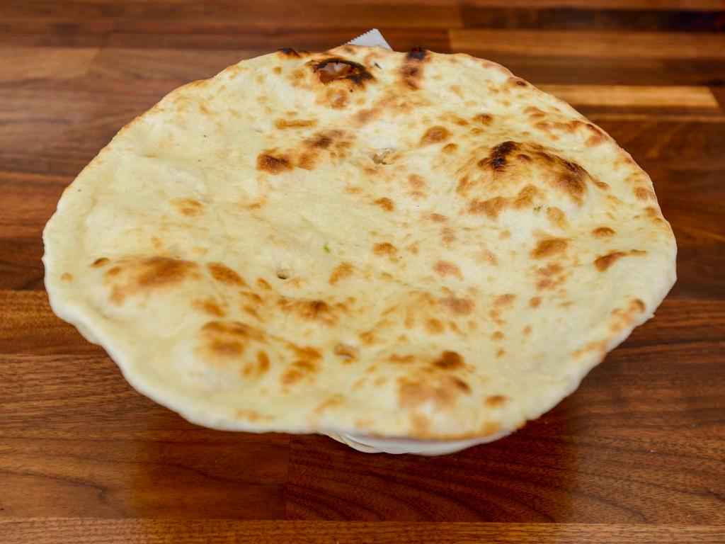 Butter Naan · Baked in a clay oven, topped with butter.