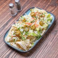 Nachos · Choice of meat topped with shredded lettuce, diced tomatoes, melted cheese, pickled jalapeno...