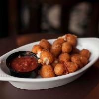 Cheese Curds · Wisconsin aged cheddar cheese fried to perfection and served with house made marinara sauce.