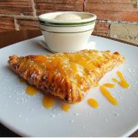 Apple Turnover · Oven baked turnover served with a scoop of ice cream and drizzled with caramel sauce.