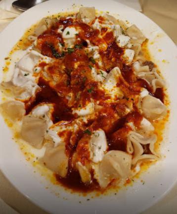 Manti · Turkish-style beef ravioli covered garlic yogurt sauce and home tomato sauce.