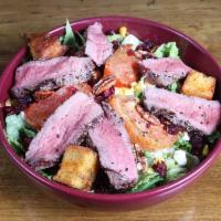 Chopped Steak Salad · Tender filet chopped and tossed with fresh lettuce, diced tomatoes vinaigrette, topped with ...