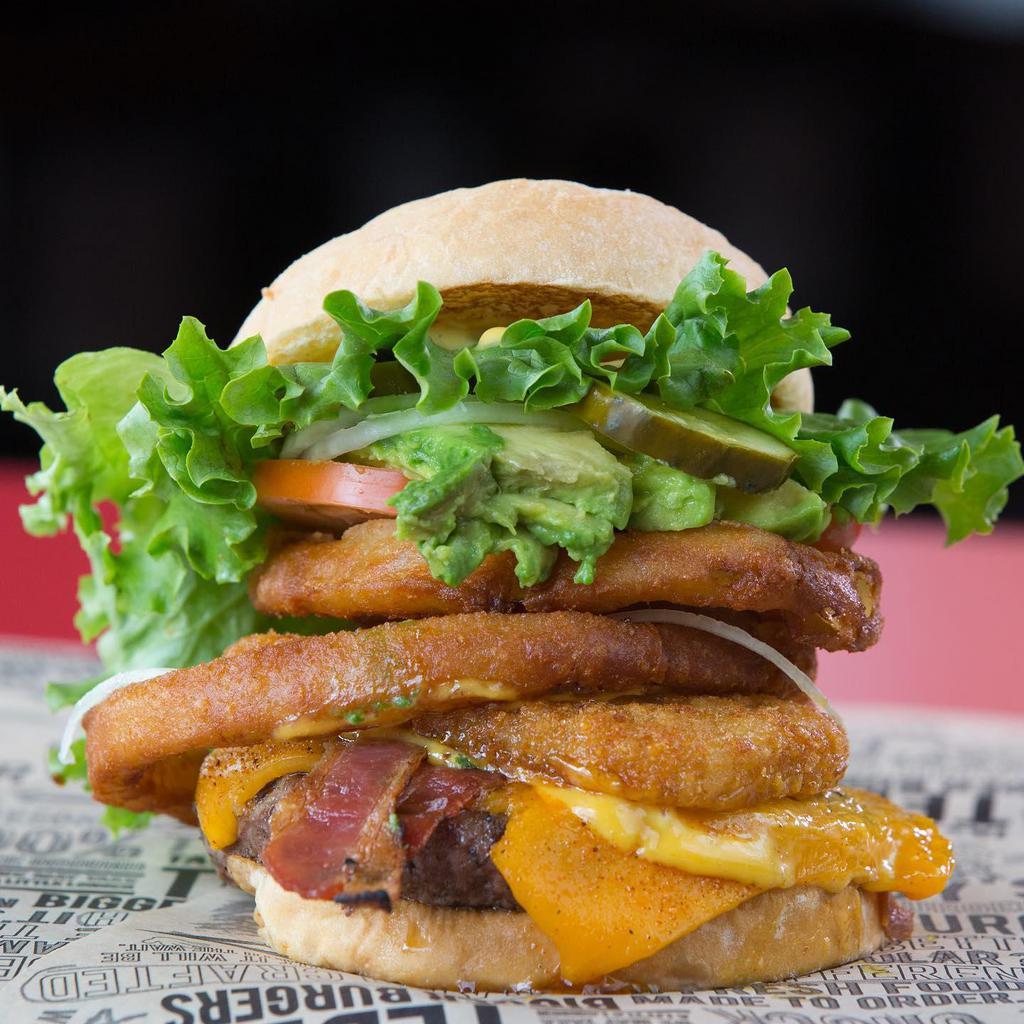 Kilauea Fire Burger · Original burger with cheddar cheese, bacon, beer battered onion rings & Kilauea fire BBQ sauce!