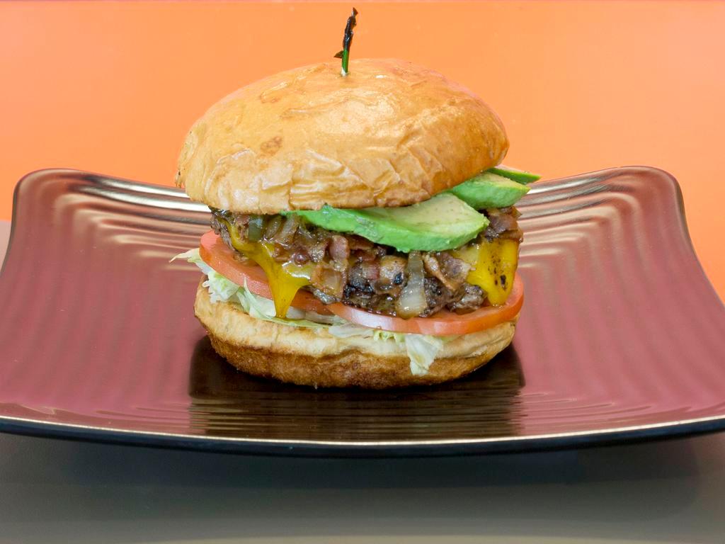 The 1984 Burger · 1/2 lb. all-natural beef burger with cheddar, avocado, lettuce, tomato & a mix of chopped bacon, caramelized onions and jalapeños.

NOTE: Cannot substitute Bacon, Onion and Jalapeño mix. Please choose Craft Your Own to customize your own burger.